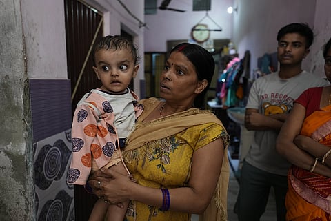 Eight-month-old Yug Goyal, one of the few survivors, with his aunt. He lost his parents & grandmother in the tragedy. Photo: Joel Michael / CSE