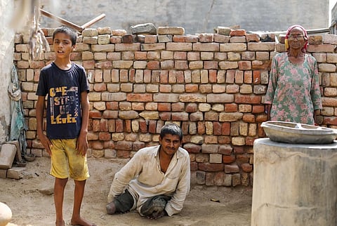 Brothers Vinod (19) and Dipu (11) are both intellectually disabled. Their grandmother, who can barely speak, feeds Dipu while Vinod begs for food from the villagers. Photo: Vikas Choudhary / CSE