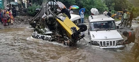 Vehicles being pulled out from floodwaters in Mohal, Kullu after heavy rains. Photo: Rohit Prashar