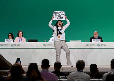 Indian protester onstage at the Global Climate Action High-Level Event (closing): Uniting on the Pathway to 2030 and Beyond session during COP28 at Expo City Dubai on December 11, 2023. Photo by COP28 / Anthony Fleyhan / Flickr
