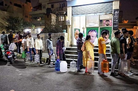Residents of a neighbourhood in Bengaluru line up for receiving water. Photo provided by Coovercolly Indresh