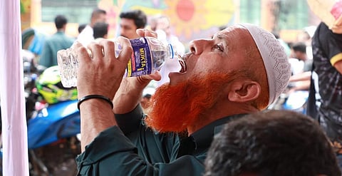 A man quenches his thirst during the record heatwave in Bangladesh last month. Photo: Al-Shahriar Rupam / IFRC, shared at @UNDRR / X (Formerly Twitter)