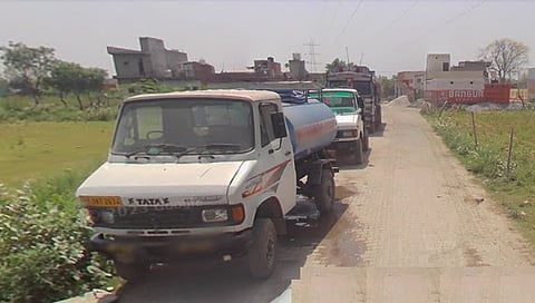 Tankers lined up to fill water from a borewell in Jeevan Nagar near Wazirpur village in Faridabad