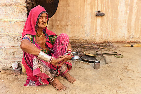 Indian senior woman preparing food. Bishnoi village. Rajasthan