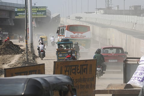 Residents move through dust-laden, smog-filled streets in Loni, Ghaziabad district, as particulate pollution remains a major concern across the Indo-Gangetic Plain.