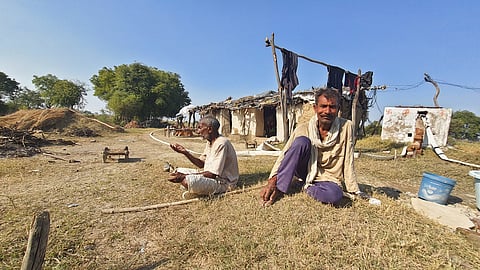 Babulal Pal (R), a farmer from Parai, and his father Bhavanidin live in a makeshift hut in the fields to protect crops from animals.