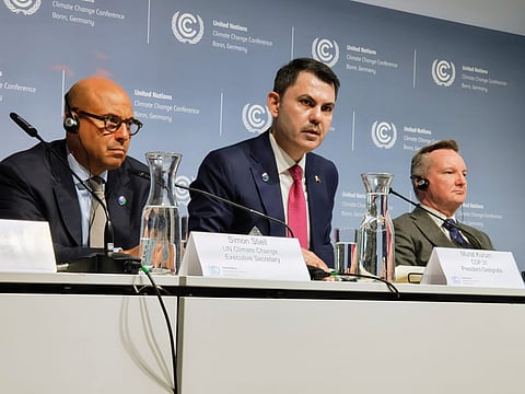 UN climate chief Simon Stiell (L) and COP31 President-Designate Murat Kurum (centre) at the mid-year climate talks.