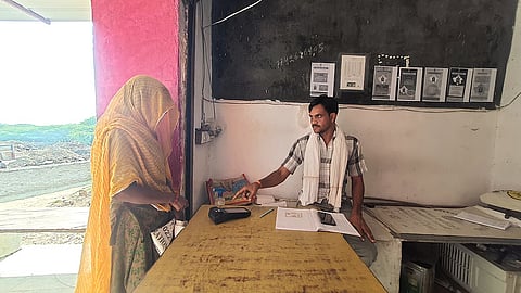 A women verifing her fingerprint on an e-POS at a fair price shop in Rajasthan.