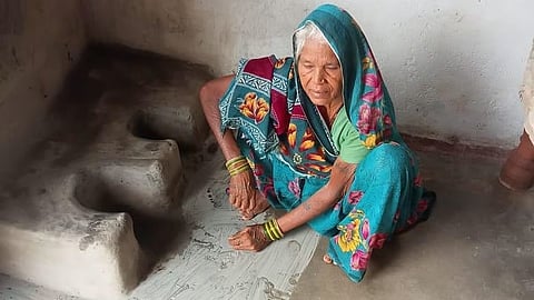 An elderly woman in Madhya Pradesh’s Chhatarpur district sits beside an unlit mud stove during the ‘chulha bandh’ protest in support of Ken-Betwa Link Project-affected families.