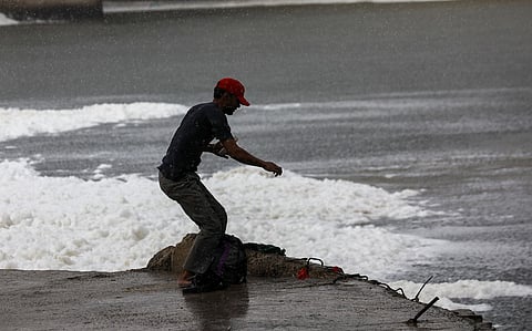 Striving for a day’s catch in the Yamuna on a monsoon day