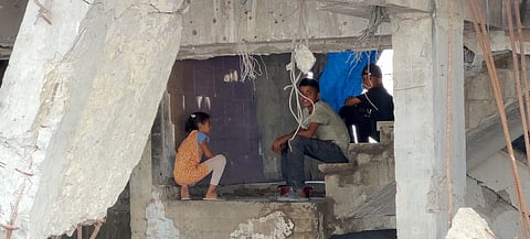Children sit inside a war-damaged building in Gaza City.