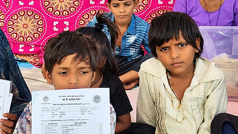 Tribal children from Kosmi village Sehore district, Madhya Pradesh sit in protest against forced eviction