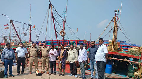 Officials of Odisha's fishery department at a harbour in Paradip, Jagatsinghpur district, to warn fishers not to venture into the sea
