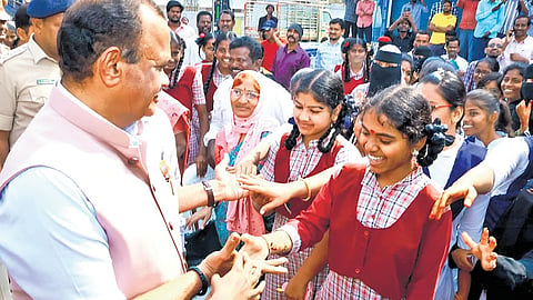 R&B Minister Komatireddy Venkat Reddy interacts with the students of Bottuguda High School in Nalgonda on Tuesday.