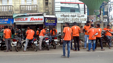 Swiggy delivery executives waiting in Chennai.