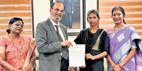 VM Muralidharan hands over the admission order with full scholarship support to R Annapoorani in Chennai on Tuesday