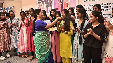 Students and teachers celebrate after the 10th class results at everwin Matriculation Higher Secondary School in Chennai on Wednesday.