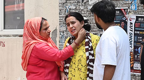 Daughter of victim Parvati in tears after receiving the tragic news.