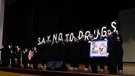 Students perform a mime show to create awareness about drugs during the event.
