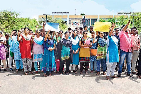 Students protest in front of Madurai Kamaraj University, demanding action against the teacher