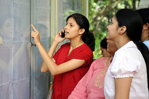 Students take a look at their results put on the notice board (Express Photo)