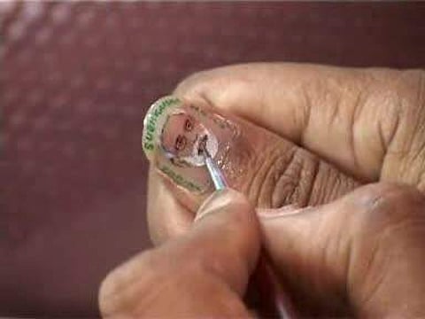 Micro artist Rakesh Shah paints on his nail greetings for Narendra Modi back in 2014 (Pic:ANI)