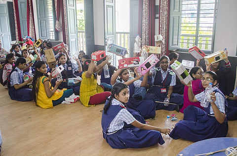 Students with their sparrow shelters during a workshop