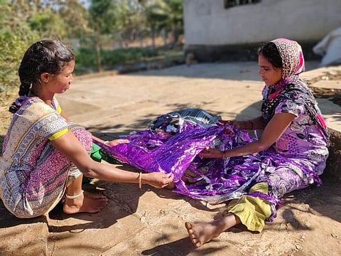 Women sorting out the plastic and gift wrapper collected from waste pickers