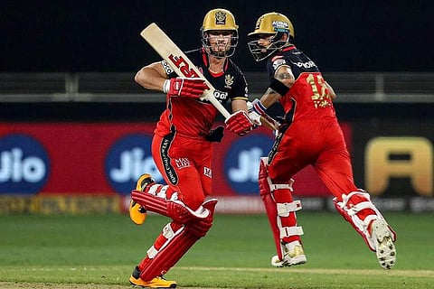 Royal Challengers Bangalore batsmen AB de Villiers and Virat Kohli run between the wickets during a cricket match of IPL 2020 (Pic: PTI)