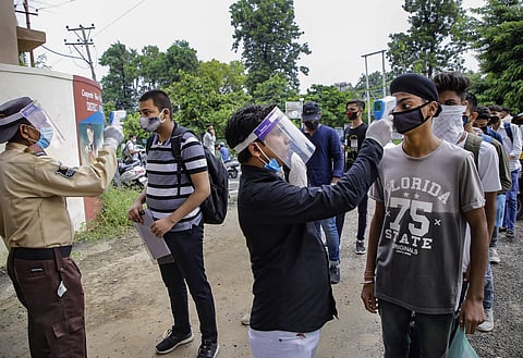 Aspirants undergo thermal screening as they wait to enter a centre in Jammu to appear for National Defence Academy (NDA) entrance exams (Pic: PTI)