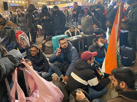 Indian students stranded in Ukraine sit at a railway station after being denied permission to board trains by local police (File Photo) | Pic: PTI