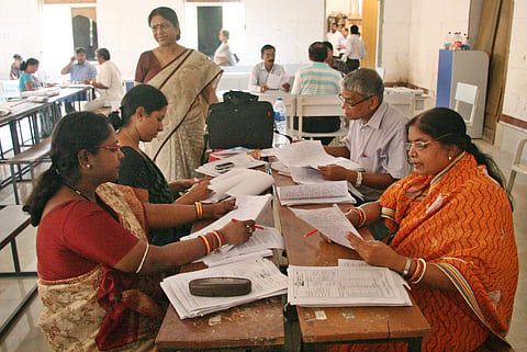 File photo of teachers correcting exam answer papers | (Pic: Express)