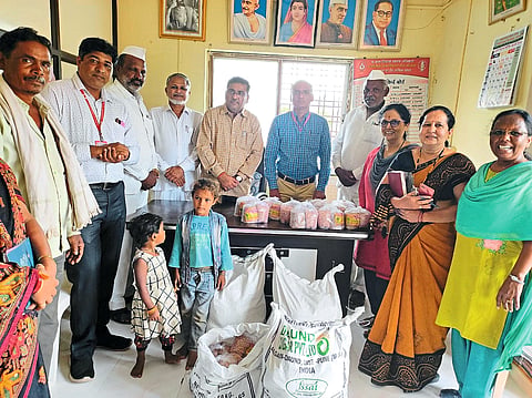 Social worker R while distributing materials to the adopted children in the integrated project office. P. Kuvar. Including Integrated Project Officer.