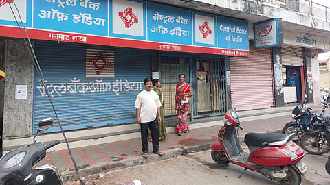 Bank customers standing in wait as bank operations are stopped