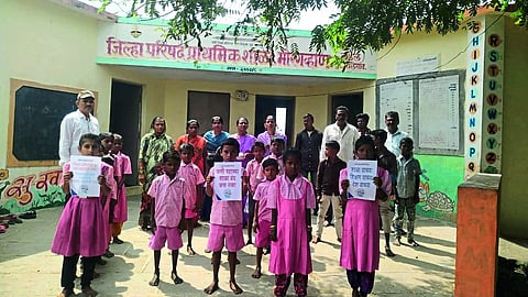 Parents and students participating in the 'Save the School' campaign in the slum school.