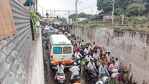 Ambulance stuck in subway traffic jam.