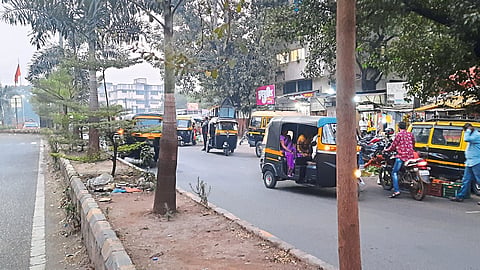 Vehicles parked on road in Dindori Naka area