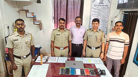 A police team including Assistant Police Inspector Sachin Bunkar showing the mobile phones and laptops seized from the inn criminals.
