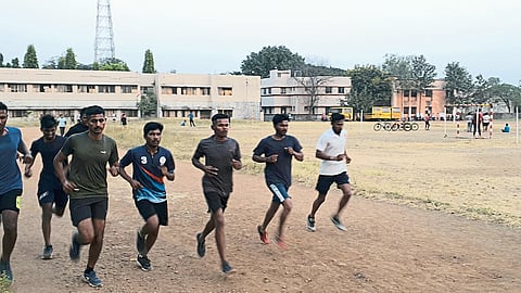 Youths practicing running for police recruitment on the grounds of Wagh College.