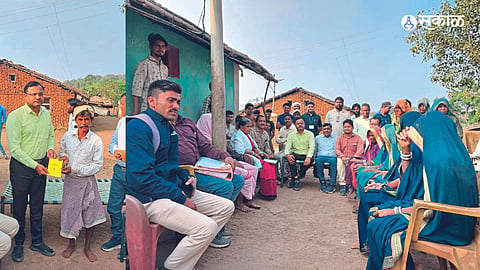 District Magistrate Pramod Bhamre, Tehsildar Aba Mahajan while distributing ration cards to the villagers on Tuesday.