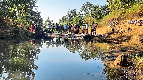 Villagers expressing their joy at the Vanrai dam, which was created through labor donation.