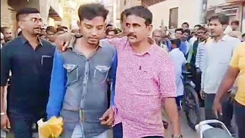 Police arresting Sharjeel Anjum Ahmed, a suspect who was carrying deer meat.