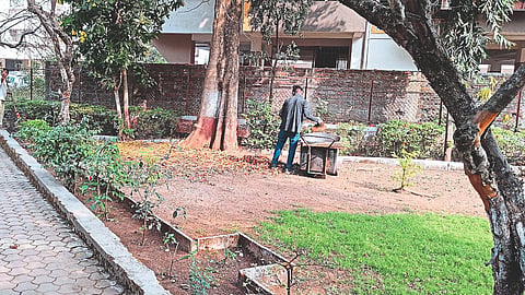 Workers collecting garbage in Kalika Park.