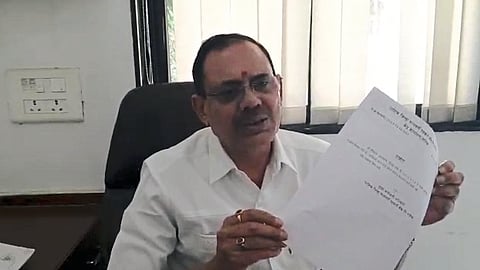 Devidas Pingle showing the NOC of District Bank.