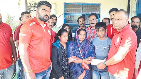 Venu P Nair while giving a relief check of one lakh rupees to the families of those who died in the railway accident. .