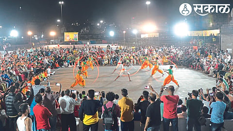 A crowd gathers at Godatira to watch the Shiva period war art demonstration organized by the Municipal Corporation and the New Year Welcome Committee