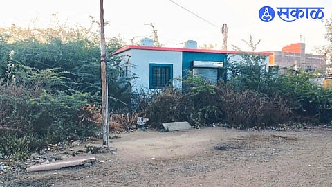 A toilet waiting to be inaugurated surrounded by prickly acacia near the entrance of the central bus station.