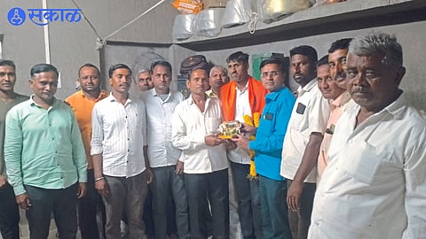 Gokul Bedse, Dinesh Thackeray and villagers felicitating Chandrakant Patil, who overcame blindness and got a job in the railways.