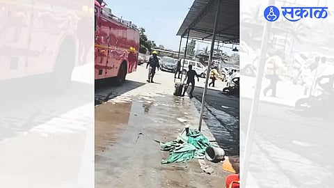 Workers put out a fire at a paint showroom in an industrial estate