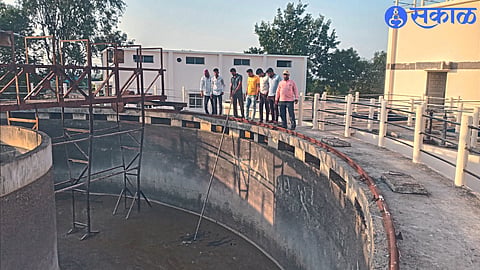 Vishnunagar villagers inspecting the silt in the water tank of Solagaon water supply scheme.